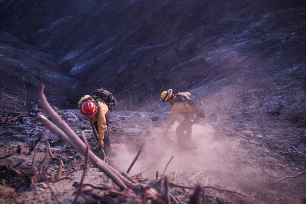 Members of a CalFire crew work to mop up hotspots from the burn scar of the Palisades Fire near Mulholland Drive in Los Angeles, California, U.S., January 15, 2025. REUTERS/David Swanson (TOP IMAGE)