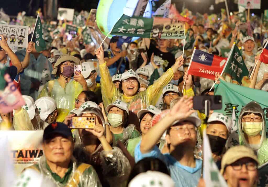 People shoot and hold slogans during a campaign rally to promote recall vote targeting 24 Nationalist Party (KMT) lawmakers in Taipei, Taiwan, Thursday, July 24, 2025. (Top Image)